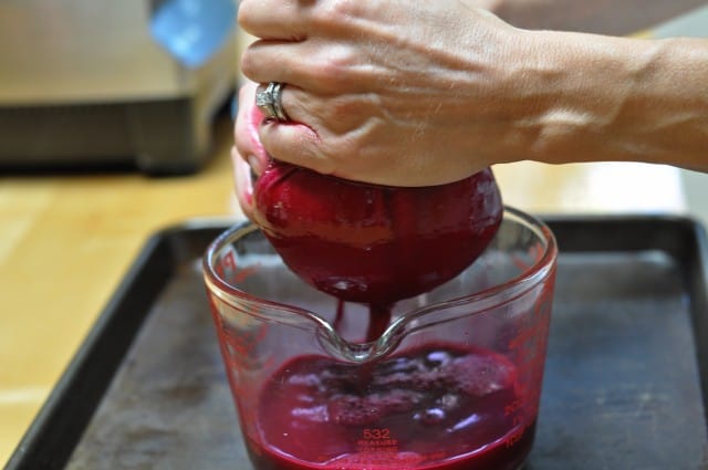 straining juice into a measuring cup