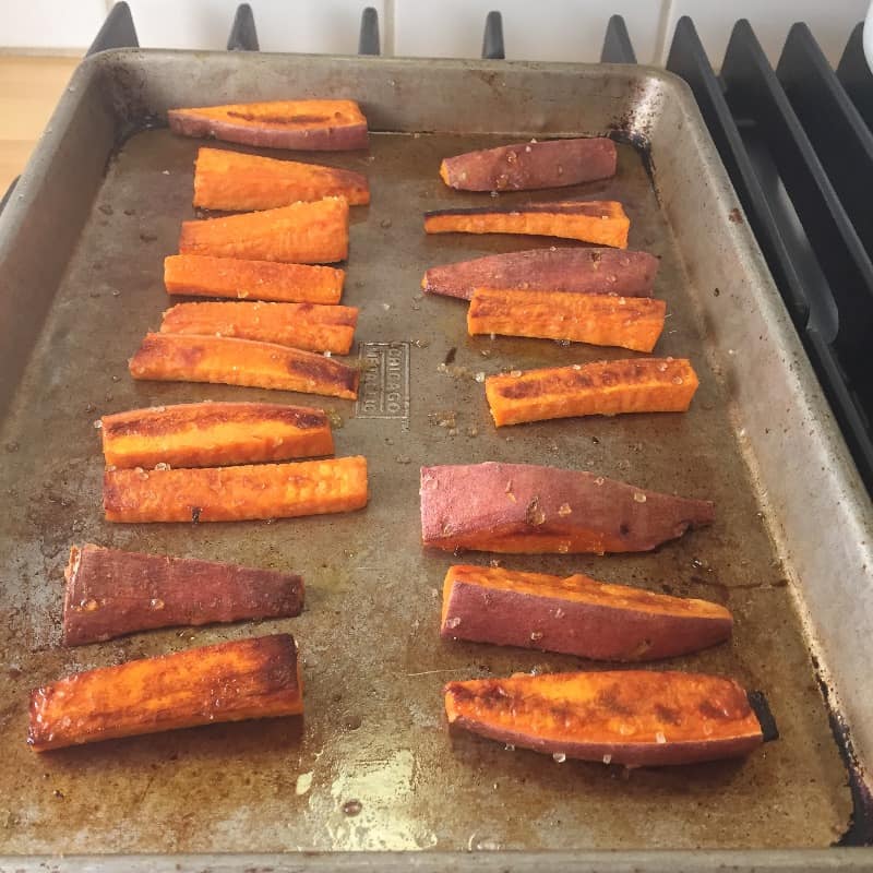 Sweet potato fries on a pan after roasting