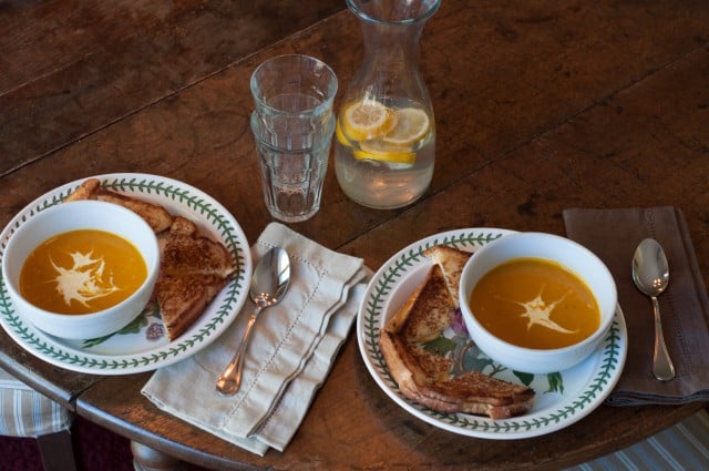 Table set with soup and sandwiches