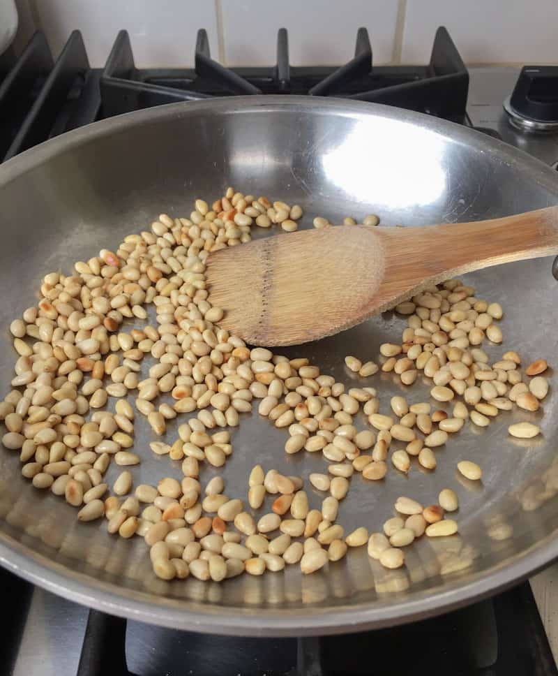 Toasting pine nuts in a pan