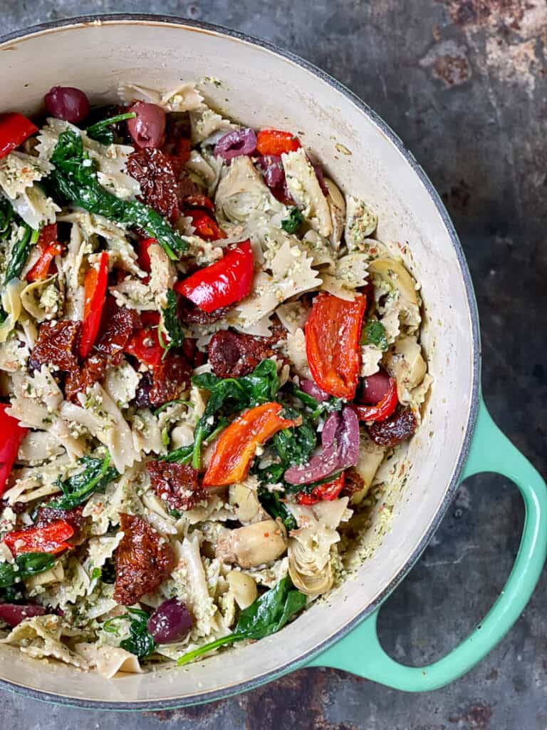 Vegan almond pesto with sun-dried tomatoes, red peppers, spinach and gluten-free pasta.