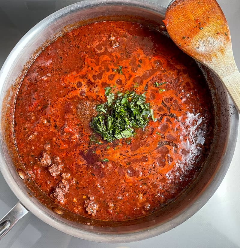 Bolognese in a pot with wooden spoon on the side