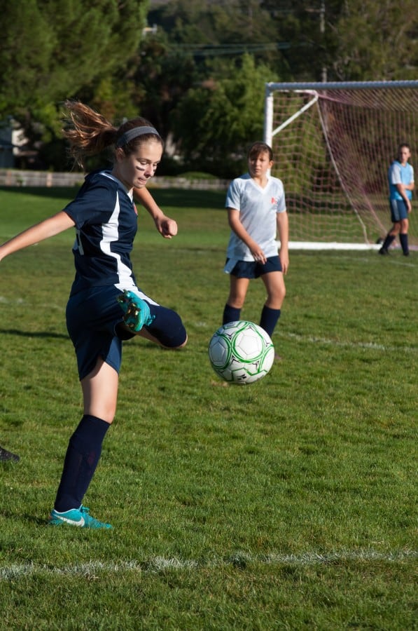 Zoe kicking soccer ball